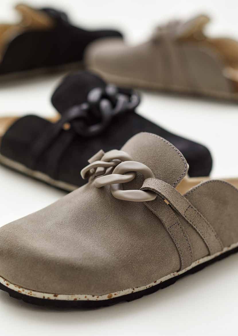 Gstaad · Soft suede and a bold chain detail.