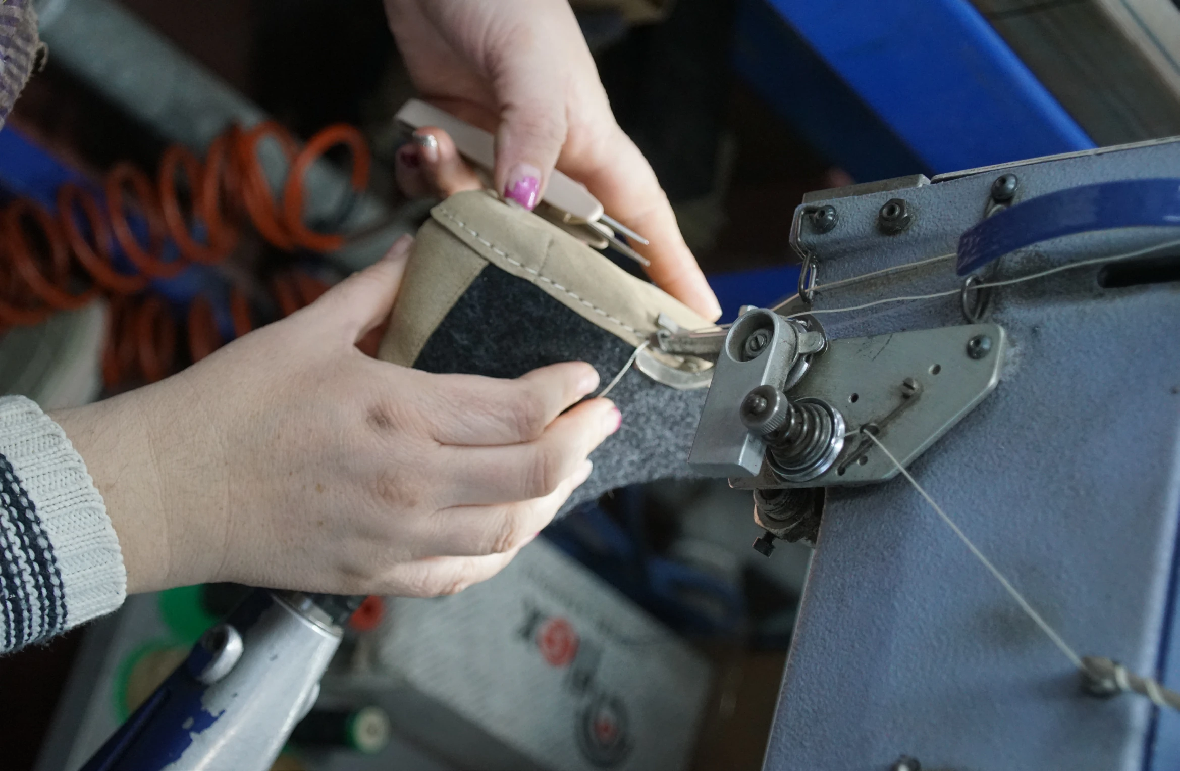 Shoemaker at work on a sewing machine